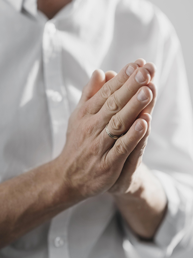 man-praying-alone-home-closeup